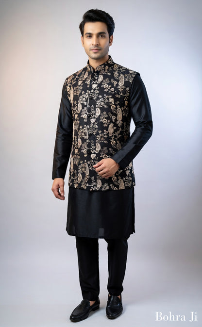 Man wearing a black kurta with a patterned jacket on a white background