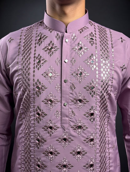 Purple embroidered shirt with intricate patterns on a dark background