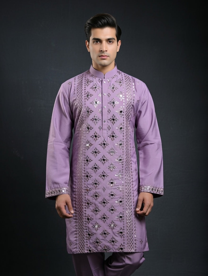 Man wearing a purple embroidered kurta against a black background