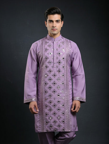 Man wearing a purple embroidered kurta against a black background