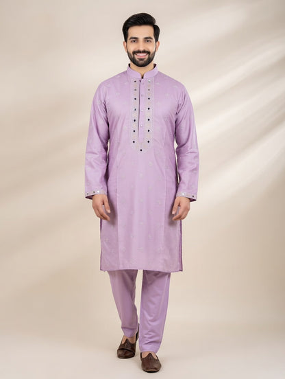 Man wearing a light purple kurta with pants on a beige background