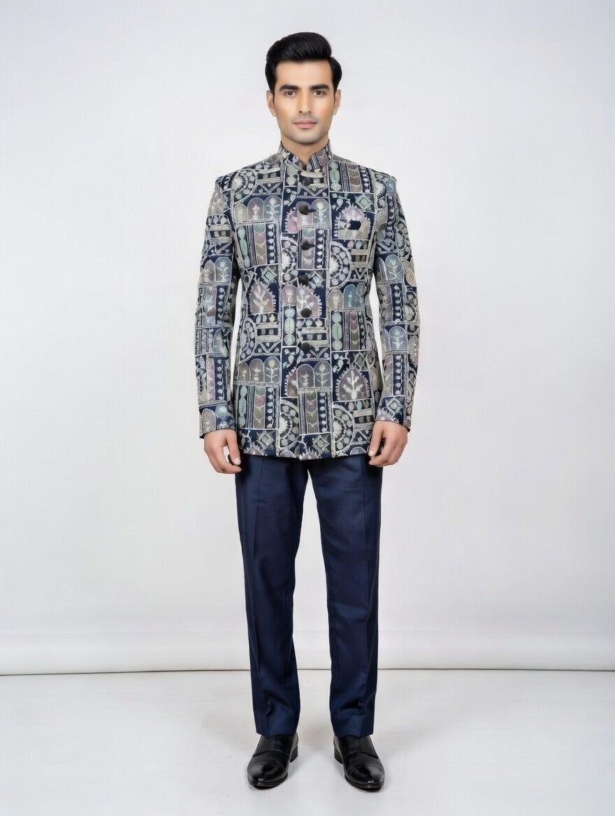 Man wearing a patterned jacket and dark pants on a white background