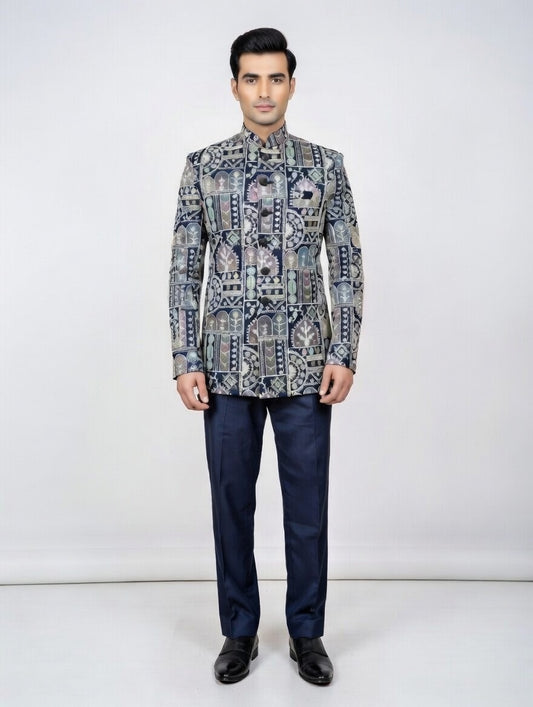 Man wearing a patterned jacket and dark pants on a white background