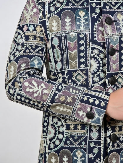 Close-up of a patterned jacket with intricate designs on a plain background