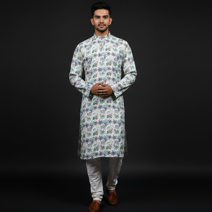 Man wearing a patterned kurta with white pants on a black background