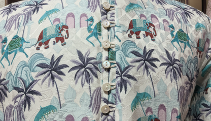 Fabric with elephant and palm tree pattern, featuring buttons.