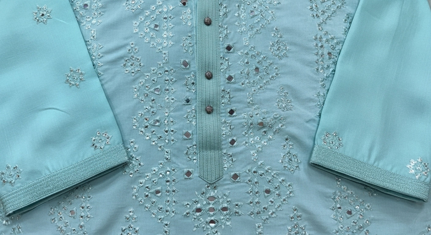 Light blue fabric with intricate embroidery and buttons