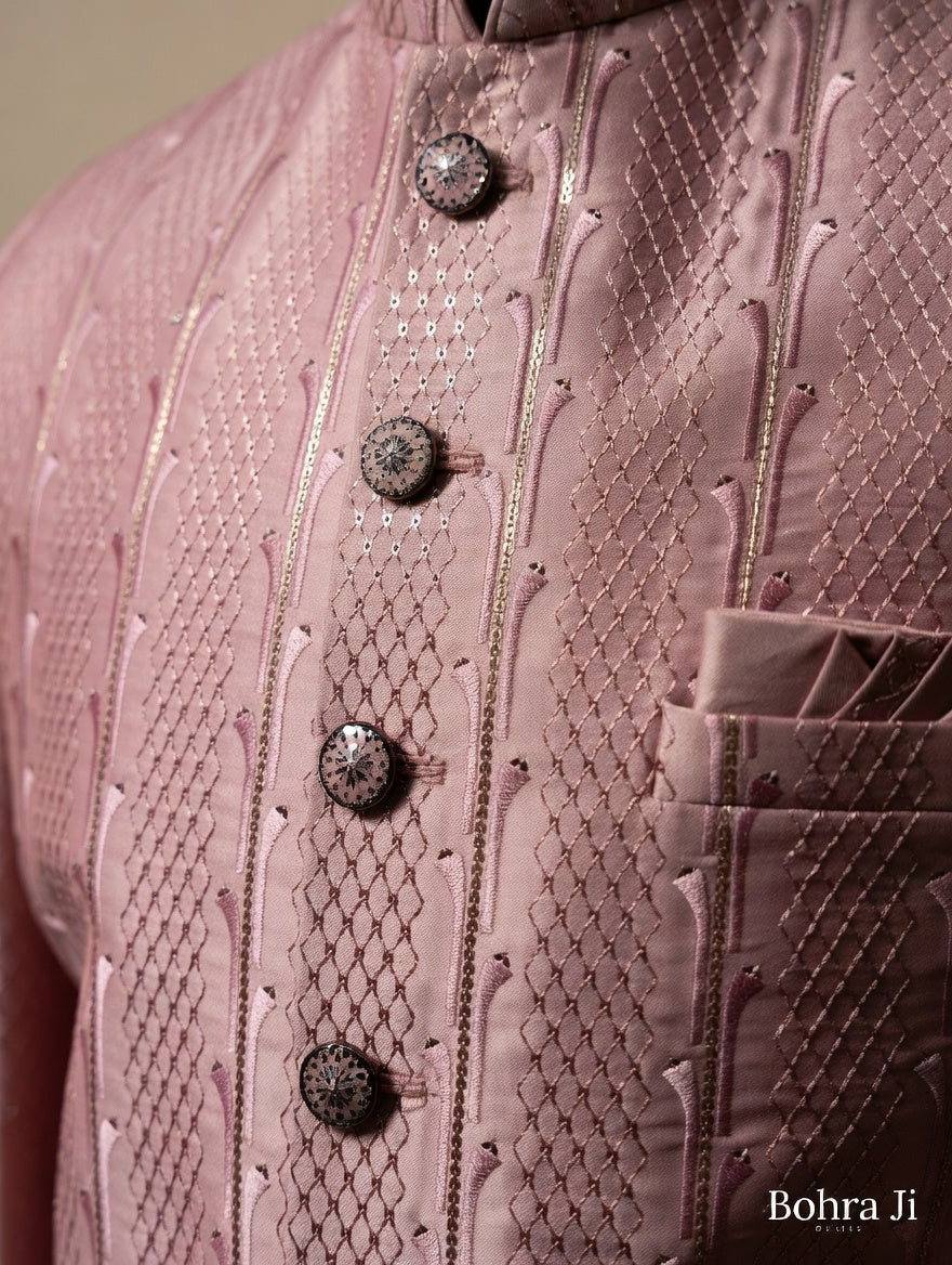 Close-up of a pink embroidered garment with buttons, featuring the brand 'Bohra Ji'.Jodhpuri Jacket